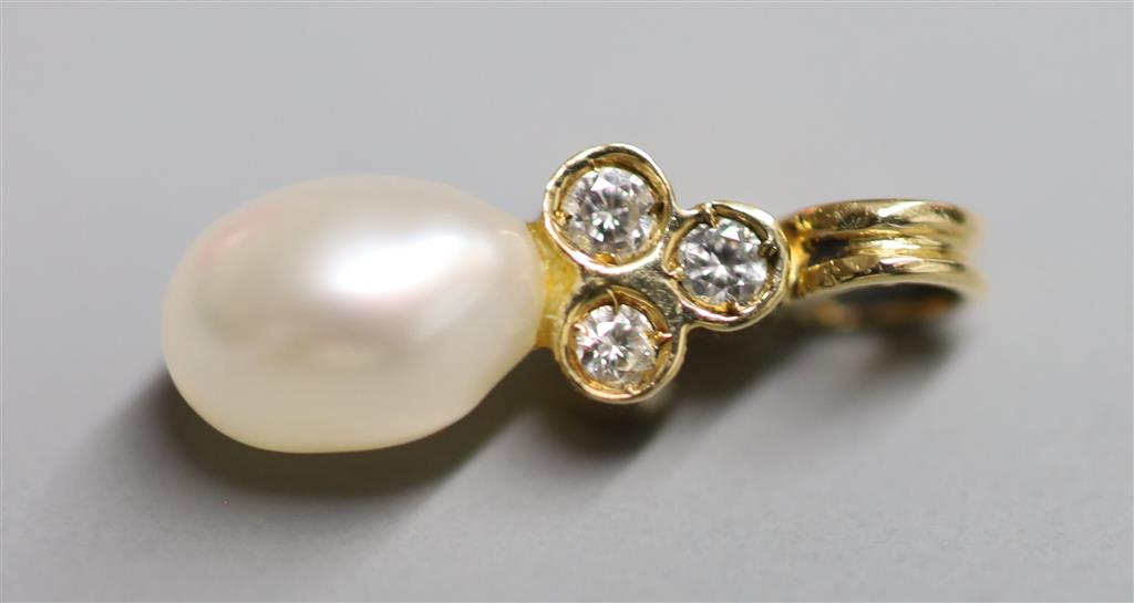 A modern yellow metal, single cultured pearl and three stone diamond chip set pendant, 16mm, gross 0.8 grams & elephant charm.